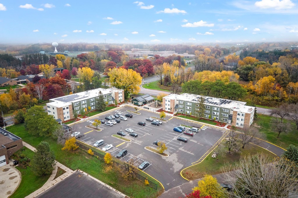 an aerial view of a parking lot and apartment buildings