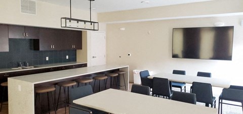 a kitchen and dining room with a table and chairs