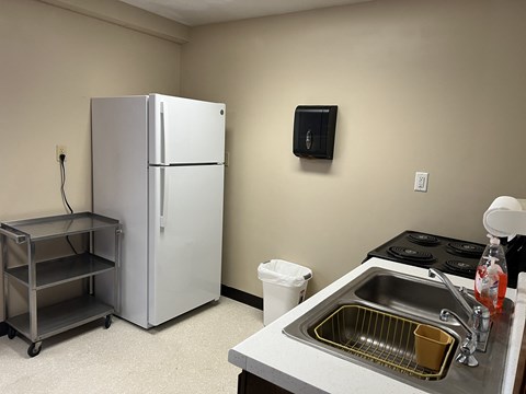 a kitchen with a refrigerator and a sink