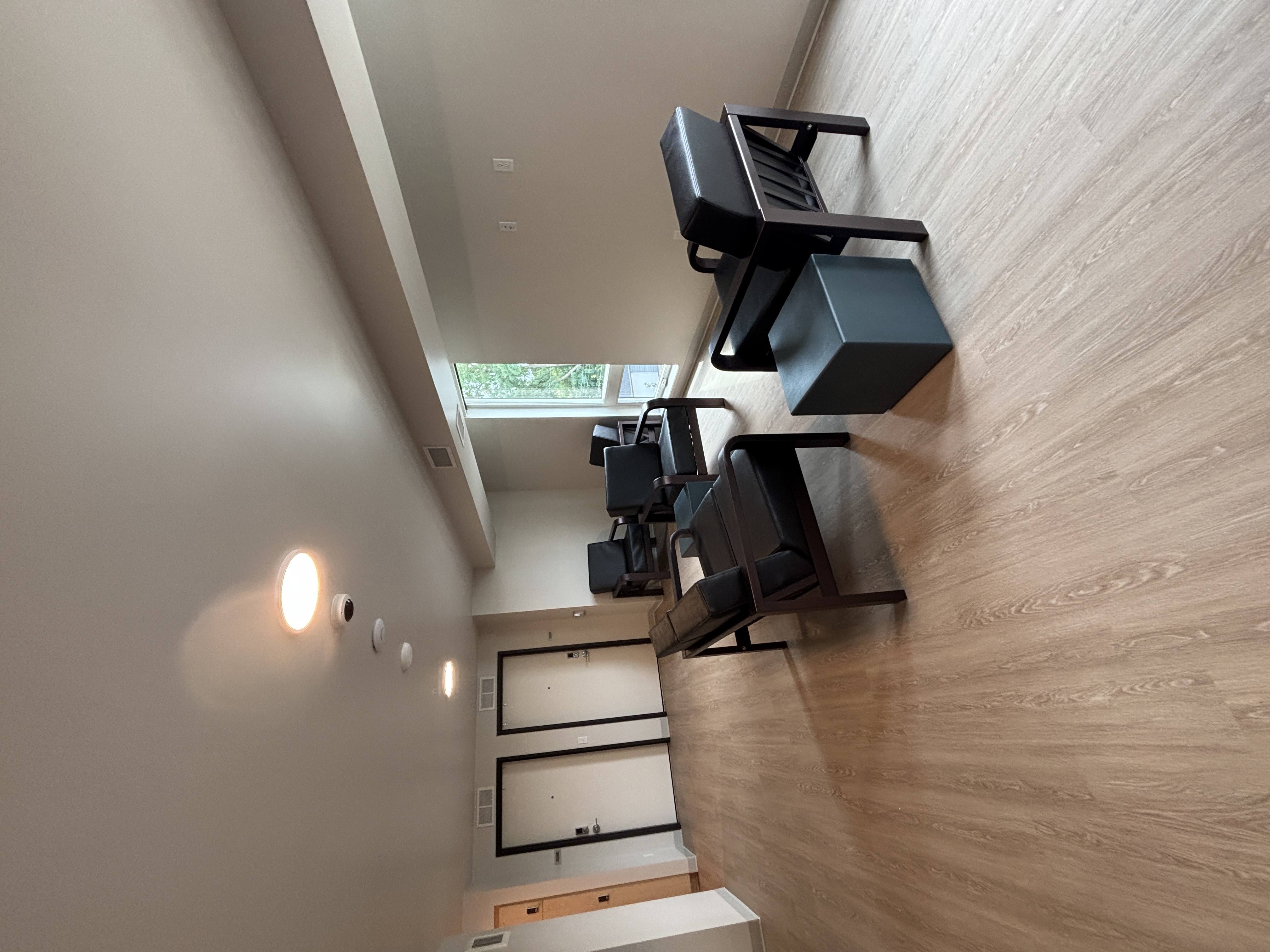 A wall-mounted speaker system is installed in a room with wooden walls.