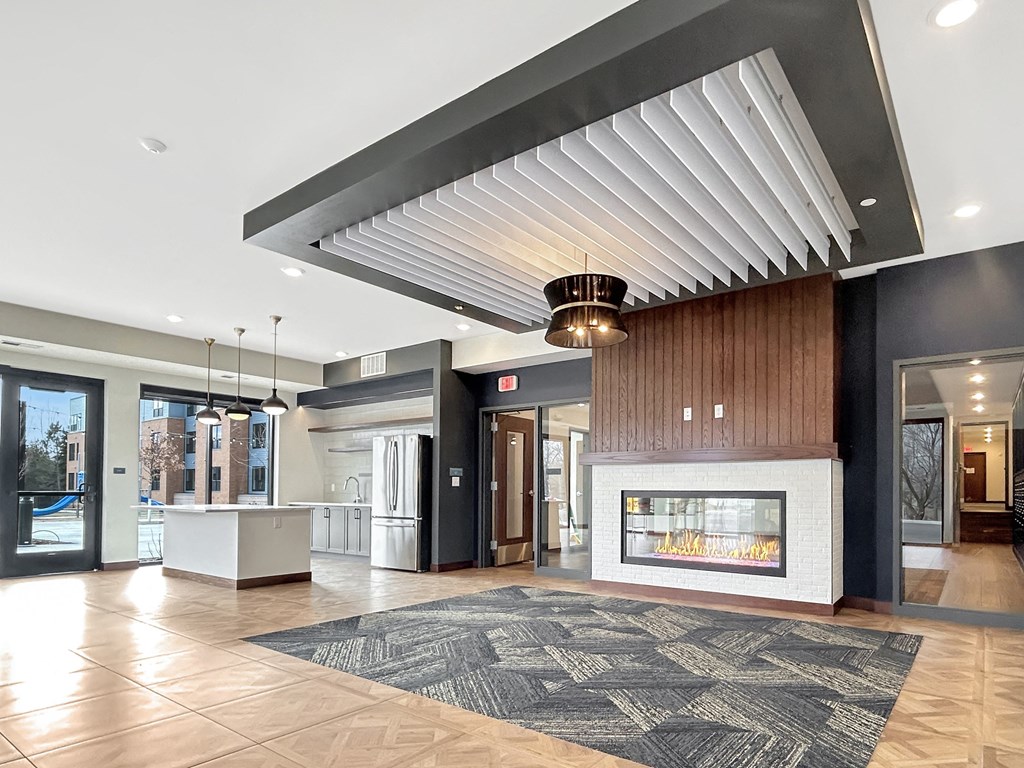 a lobby with a fireplace and a large rug