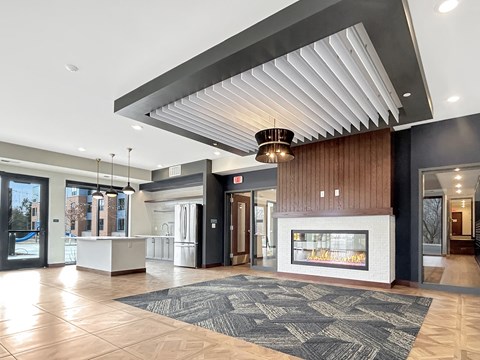 a lobby with a fireplace and a large rug