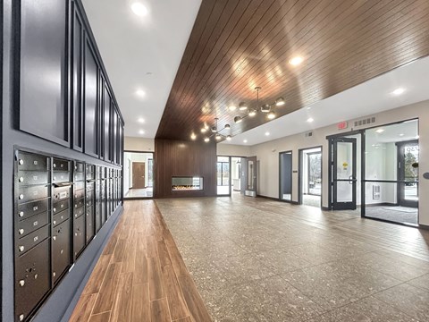 a large room with wood floors and a fireplace