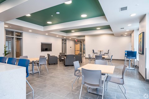 A conference room with a white table and chairs.