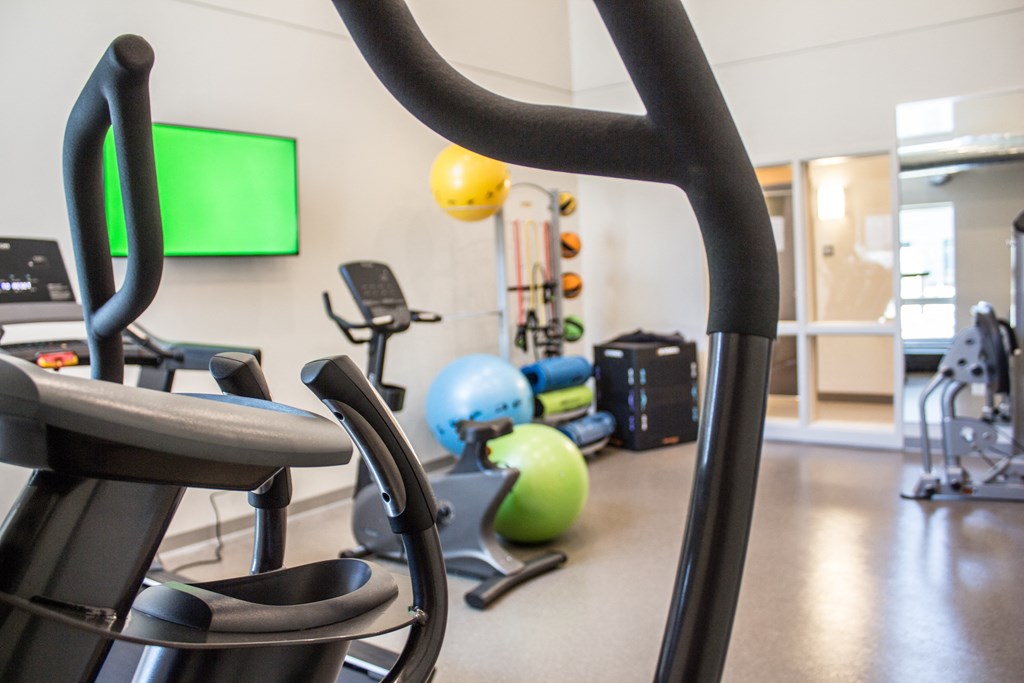 a gym with weights and other exercise equipment in a building