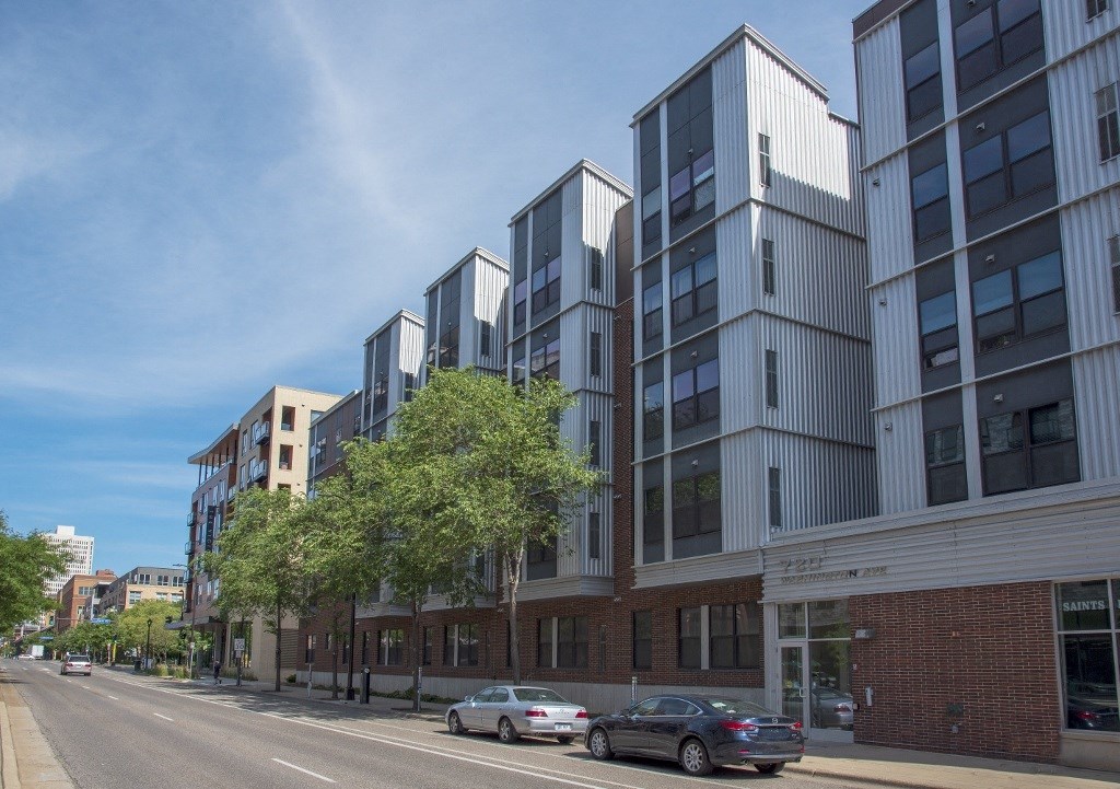 a view of a city street with tall buildings and cars