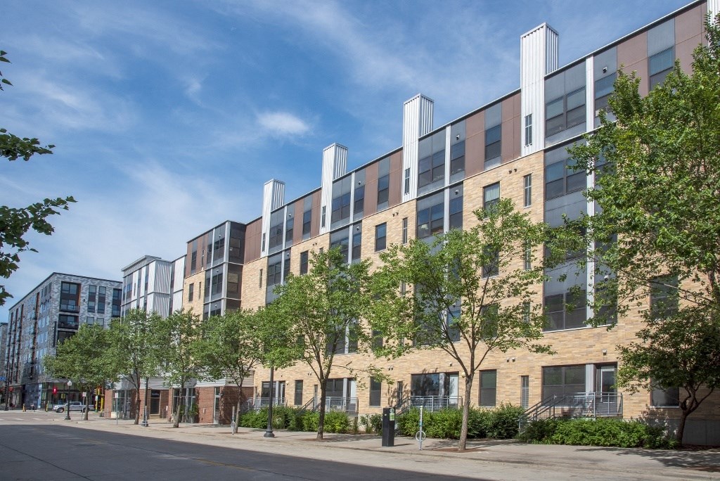 a rendering of an apartment building on a city street