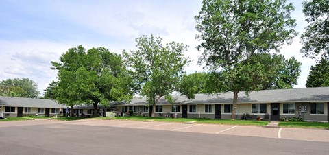 an empty parking lot in front of an apartment building