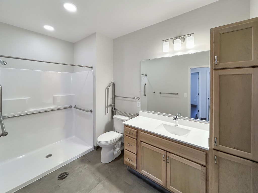 A bathroom with a white tub, sink, and toilet.