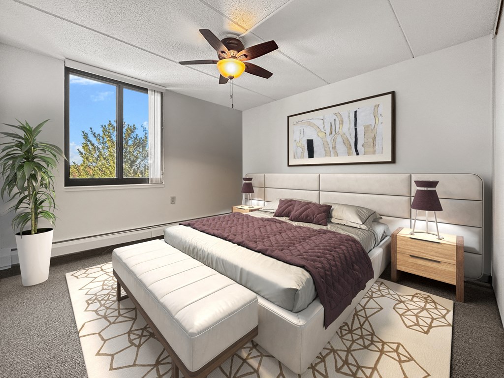 a bedroom with a bed and a ceiling fan