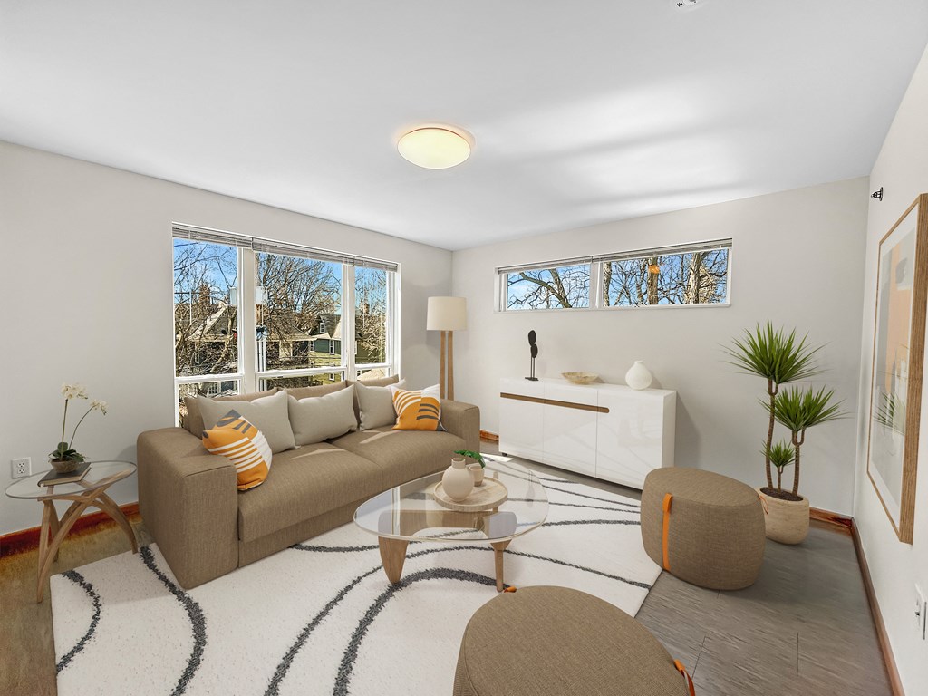 a living room with a couch and a glass coffee table