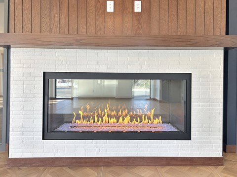a fireplace is shown in a living room with a wood floor