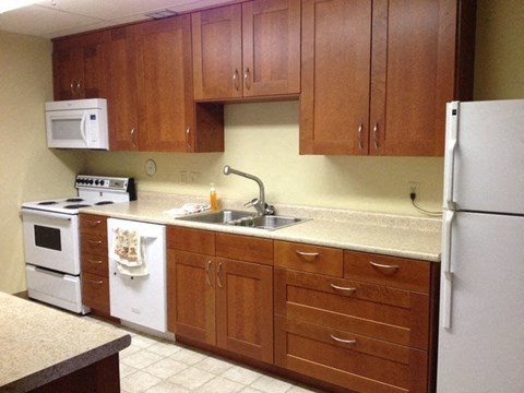 a kitchen with white appliances and wooden cabinets