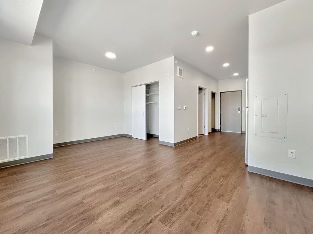 A room with wooden floors and white walls.