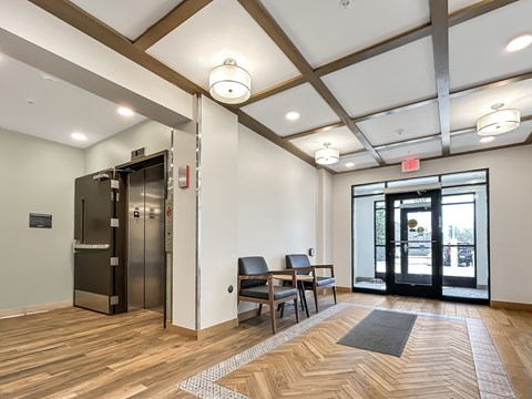 A room with a wooden floor and a black door.