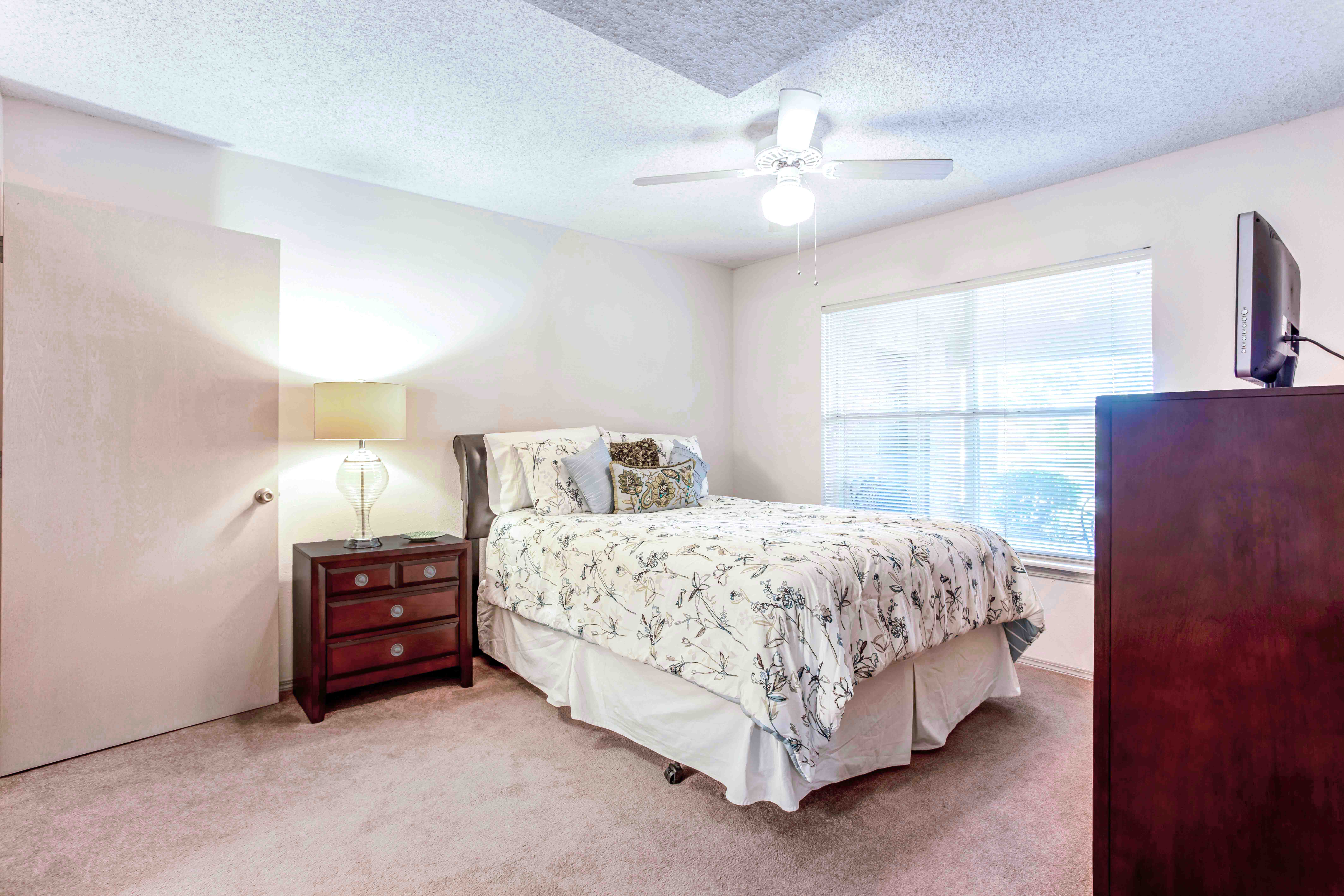 a bedroom with a bed and a window