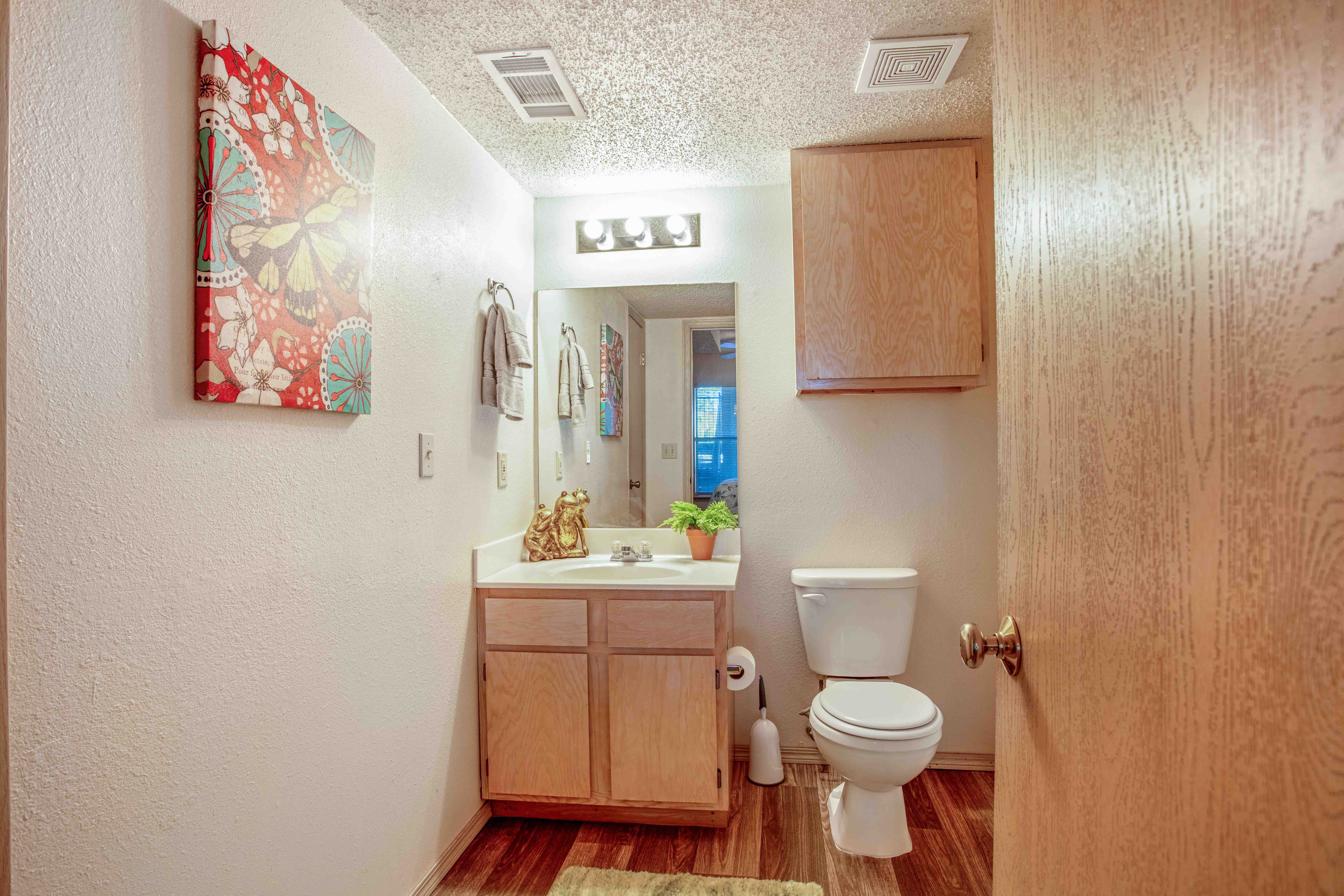 a bathroom with a toilet sink and mirror