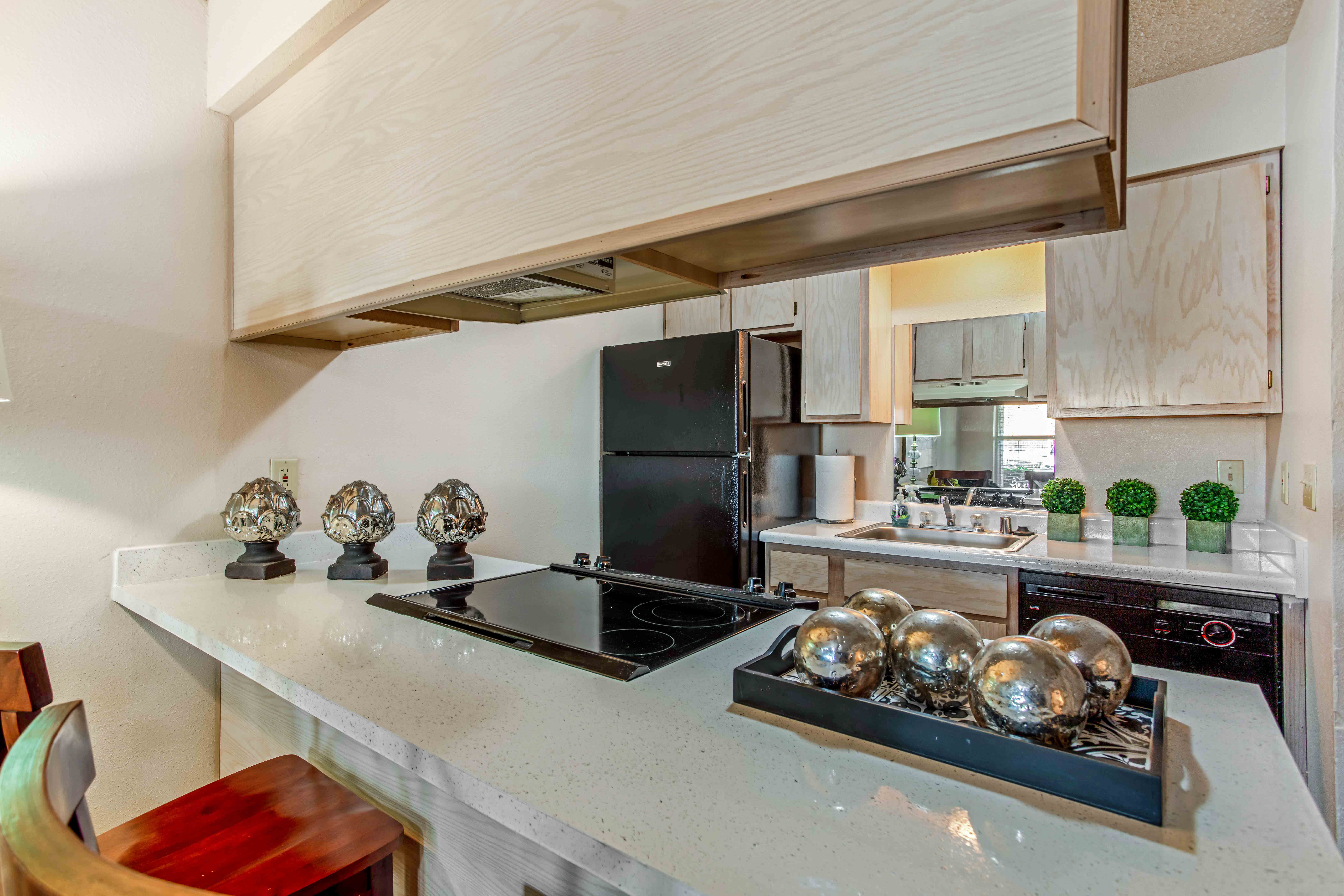 a kitchen with a large counter and a stove top oven