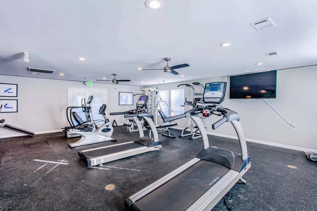 a gym with treadmills and other exercise equipment