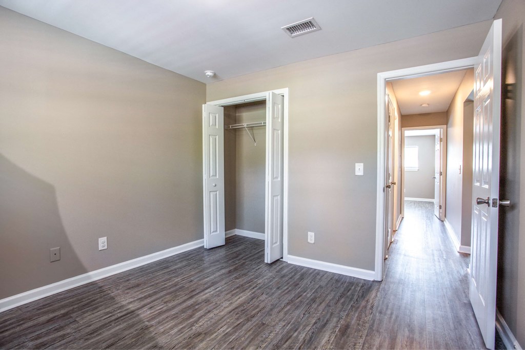 the living room and hallway of a new home with wood flooring