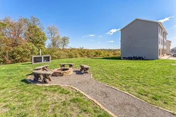 a backyard with a picnic table and a building