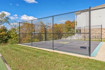 a basketball court in a park next to a building