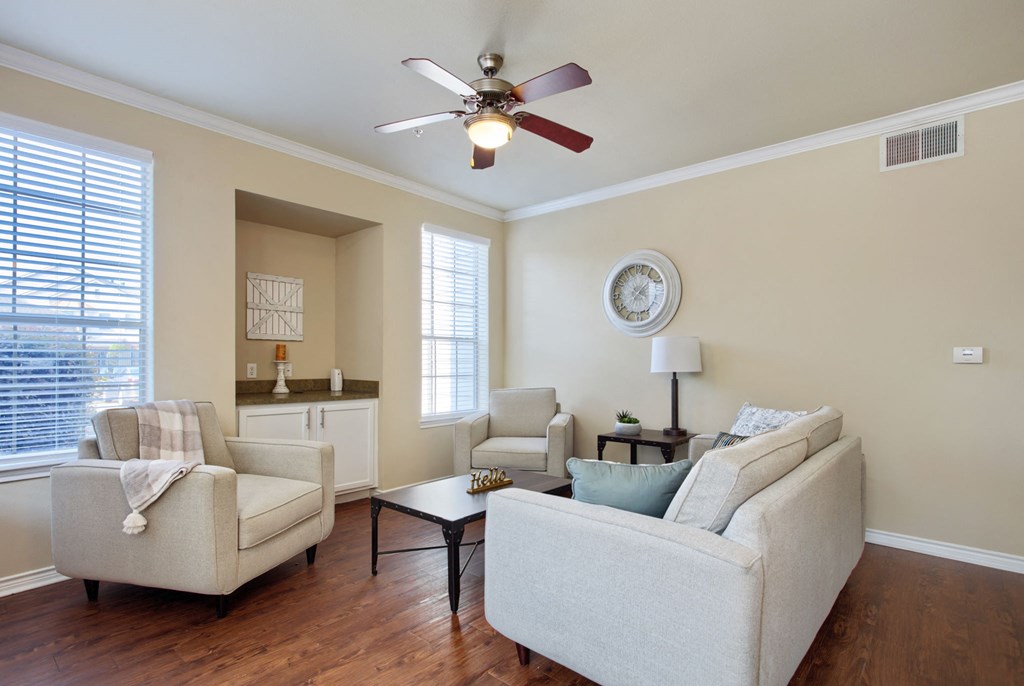 a living room with two couches and two chairs