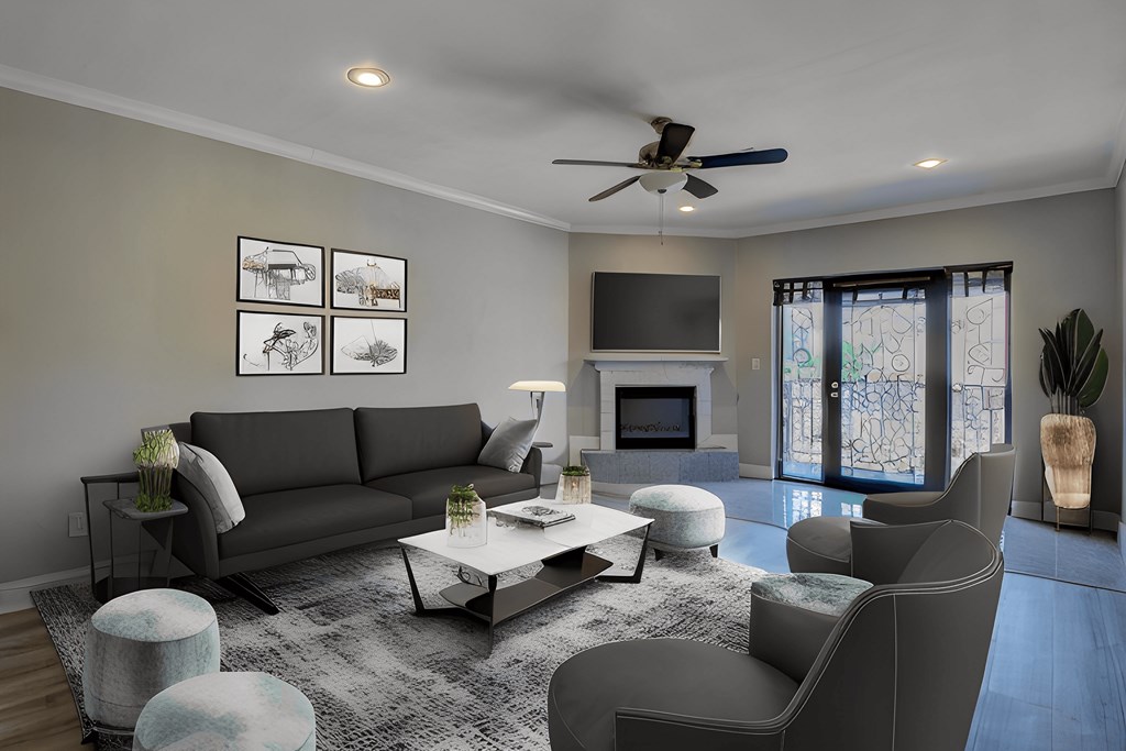 A modern living room with a grey sofa, a coffee table, and a ceiling fan.