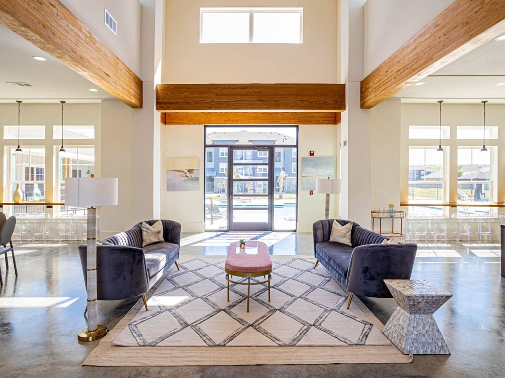 a living room with couches and a coffee table in front of a door