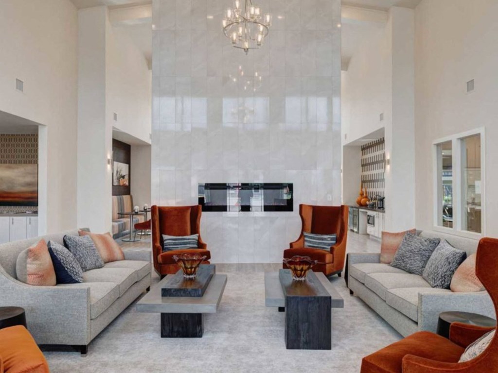 a living room with couches and chairs and a fireplace