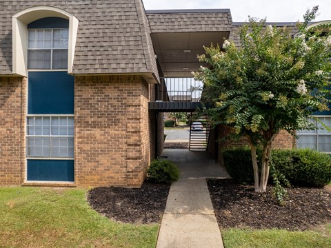 a view of the front of a house with a walkway