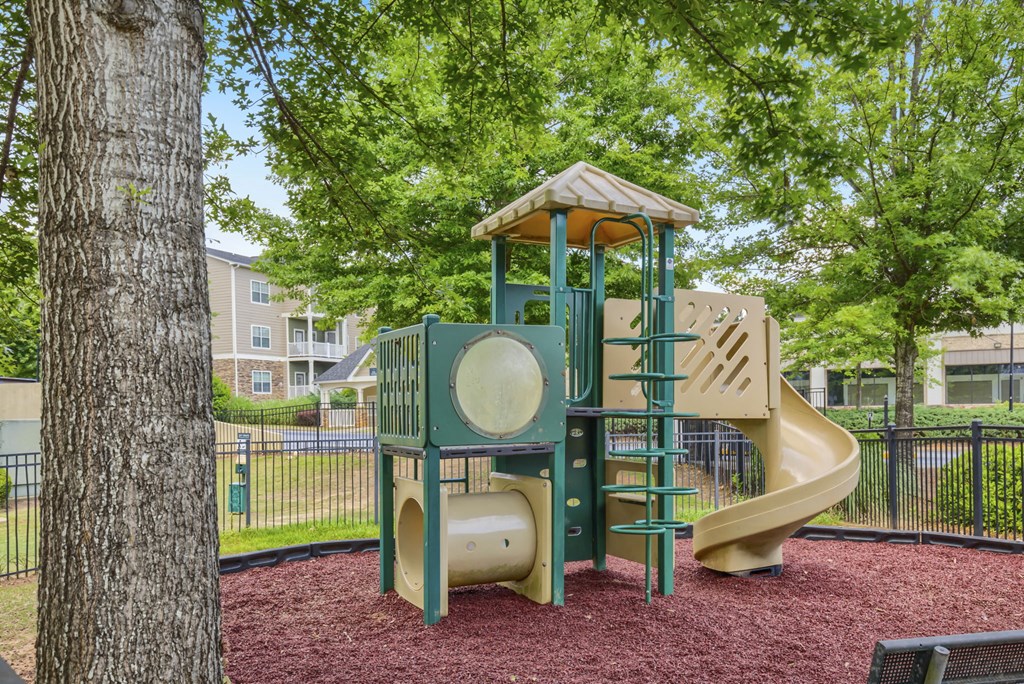 a playground with a jungle gym and a slide