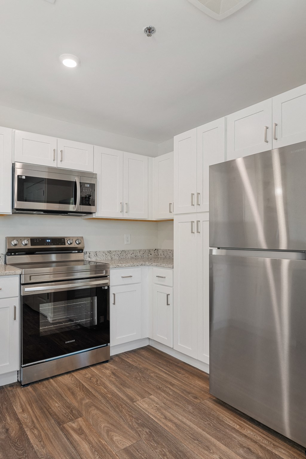 a kitchen with stainless steel appliances and white cabinets