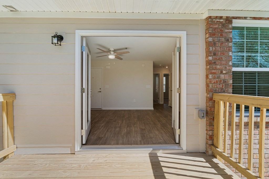 the view from the front porch of a house with a door open to a hallway