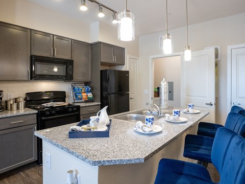 a kitchen with granite counter tops and stainless steel appliances
