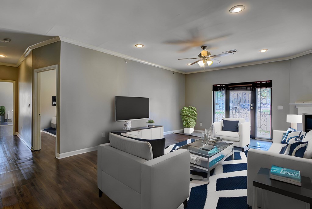 A modern living room with a white couch and a television.