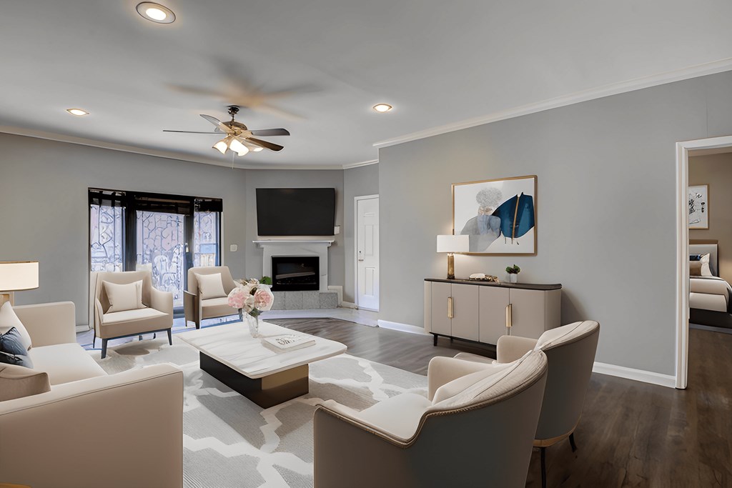 A living room with a fireplace and a painting on the wall.