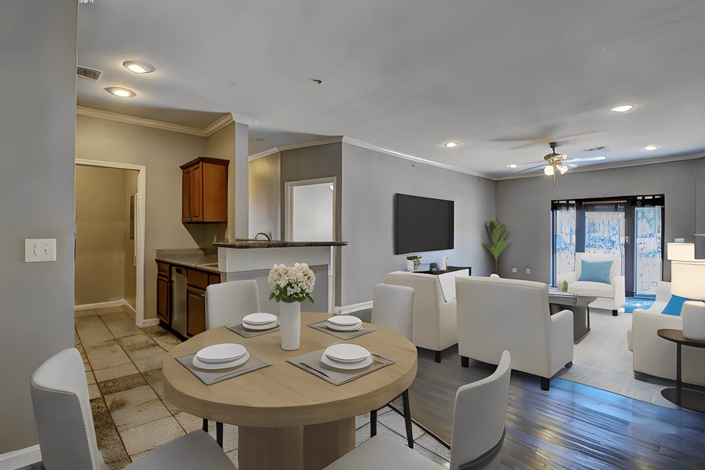 A modern dining room with a round table set for four.