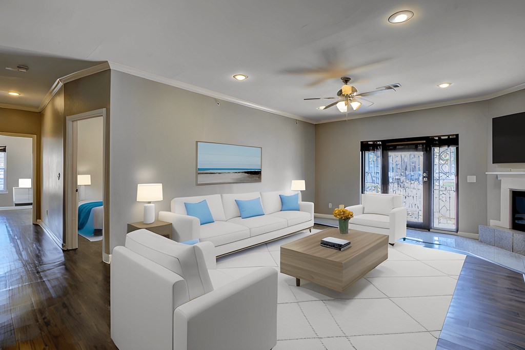 A modern living room with a white sofa set and a wooden coffee table.