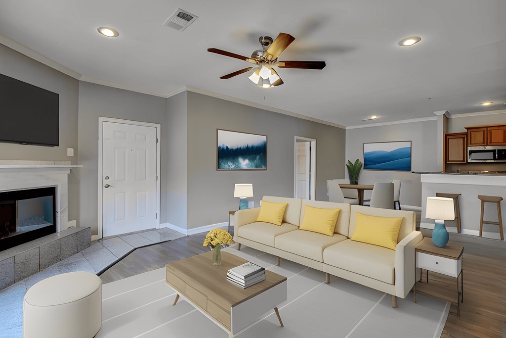 A living room with a white couch and a fireplace.