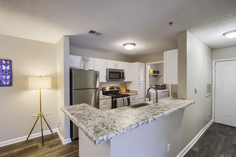 a kitchen with a granite counter top and stainless steel appliances