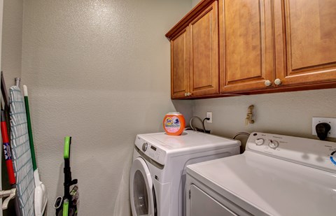 A small laundry room with a washer and dryer.