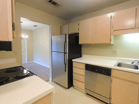 a kitchen with a stove and a refrigerator