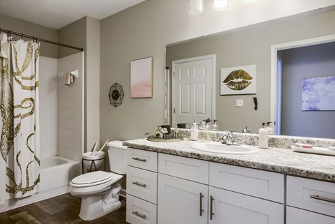 a bathroom with a white toilet next to a white sink