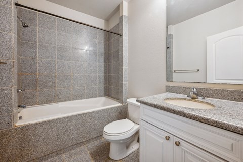 full bath with decorative tile at the Versailles