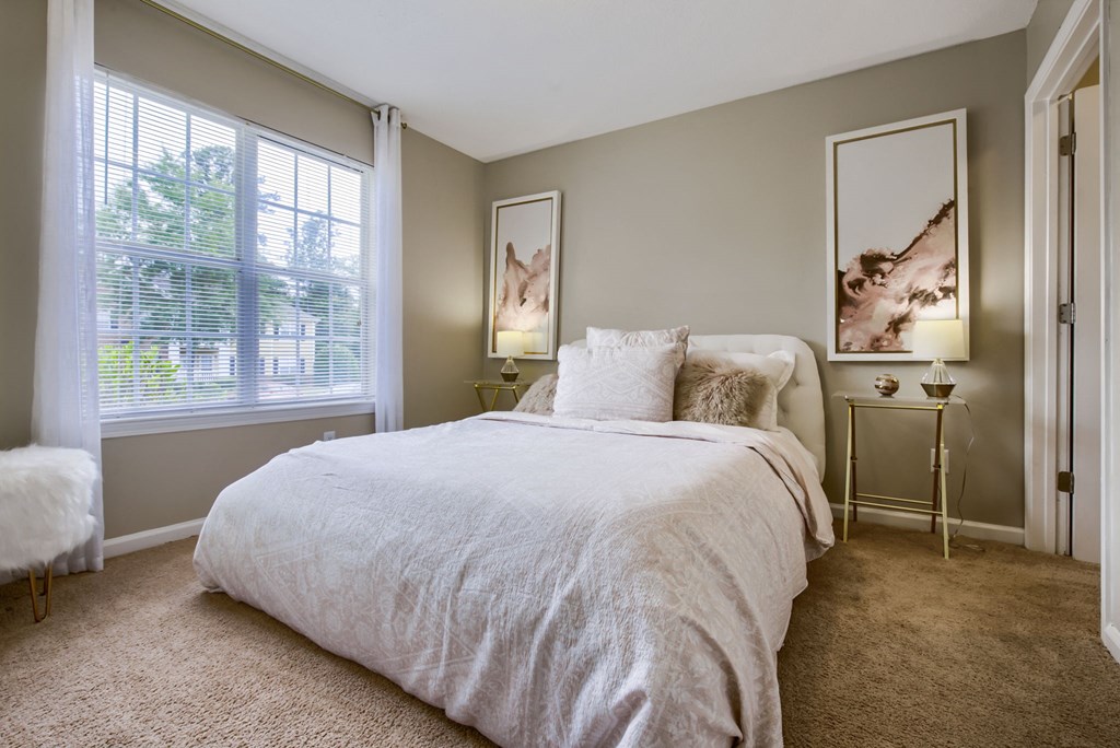 a bedroom with a bed and two windows