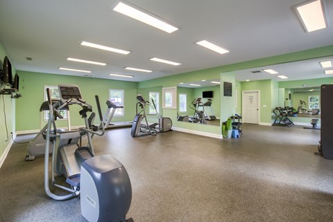 a large fitness room with treadmills and other exercise equipment
