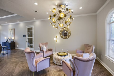 a living room filled with furniture and a large chandelier