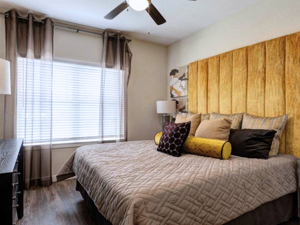 a bedroom with a large bed and a window