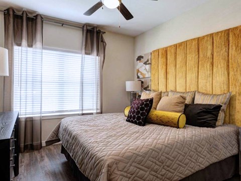 a bedroom with a large bed and a window